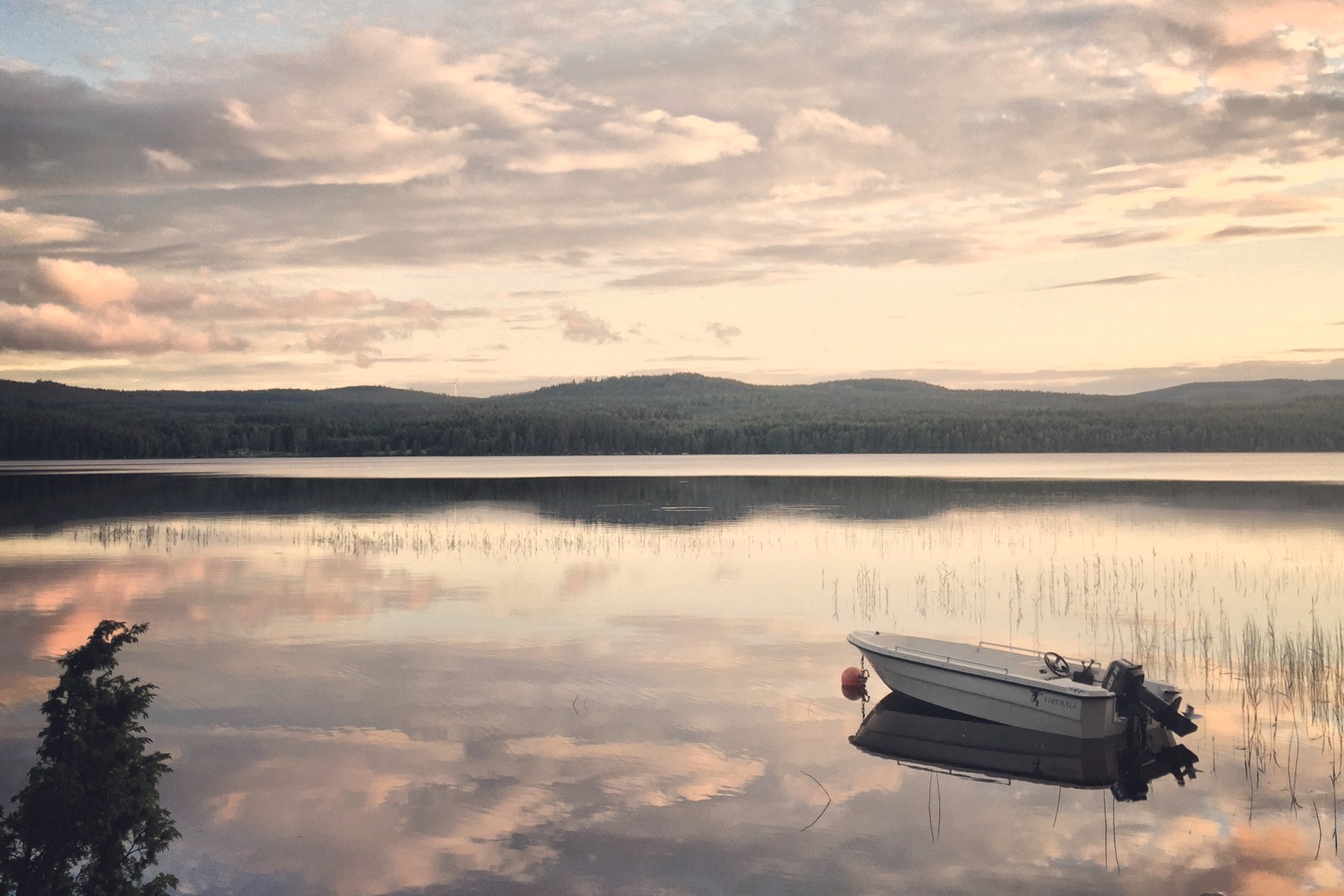 A still boat on a calm Swedish lake at sunrise, symbolising balance and inner calm